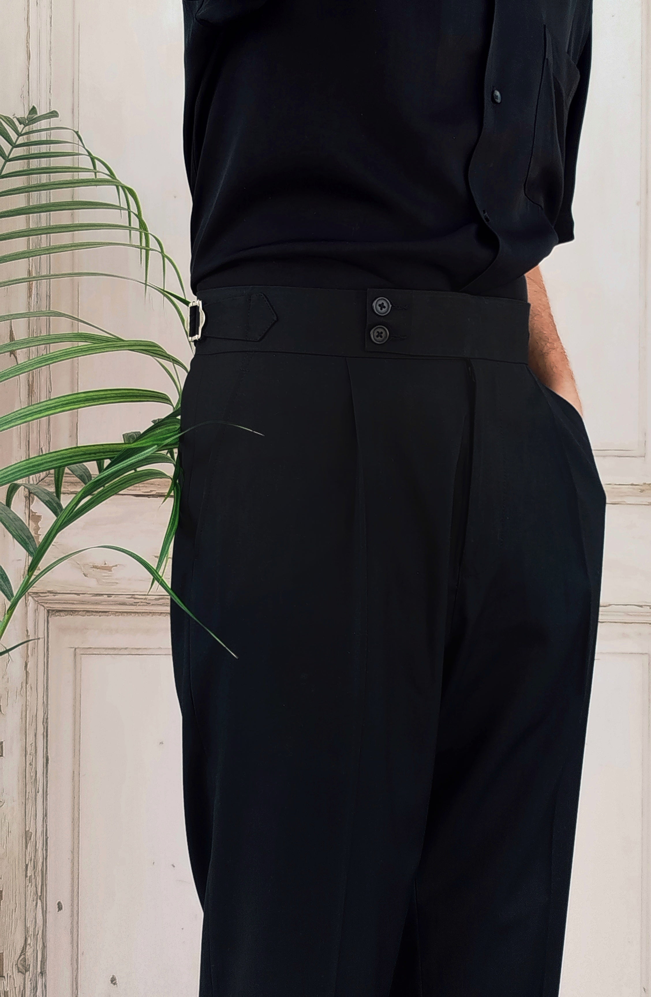 Premium black formal pants for men styled with minimal and modern menswear