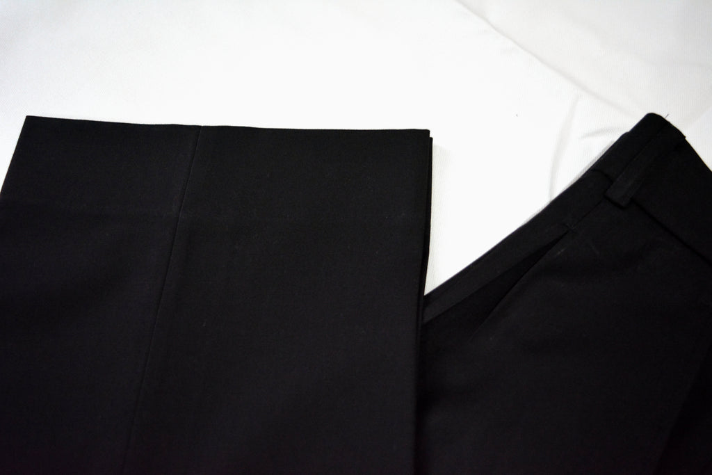 Black loose pleated pants fabric texture showing soft, breathable weave
