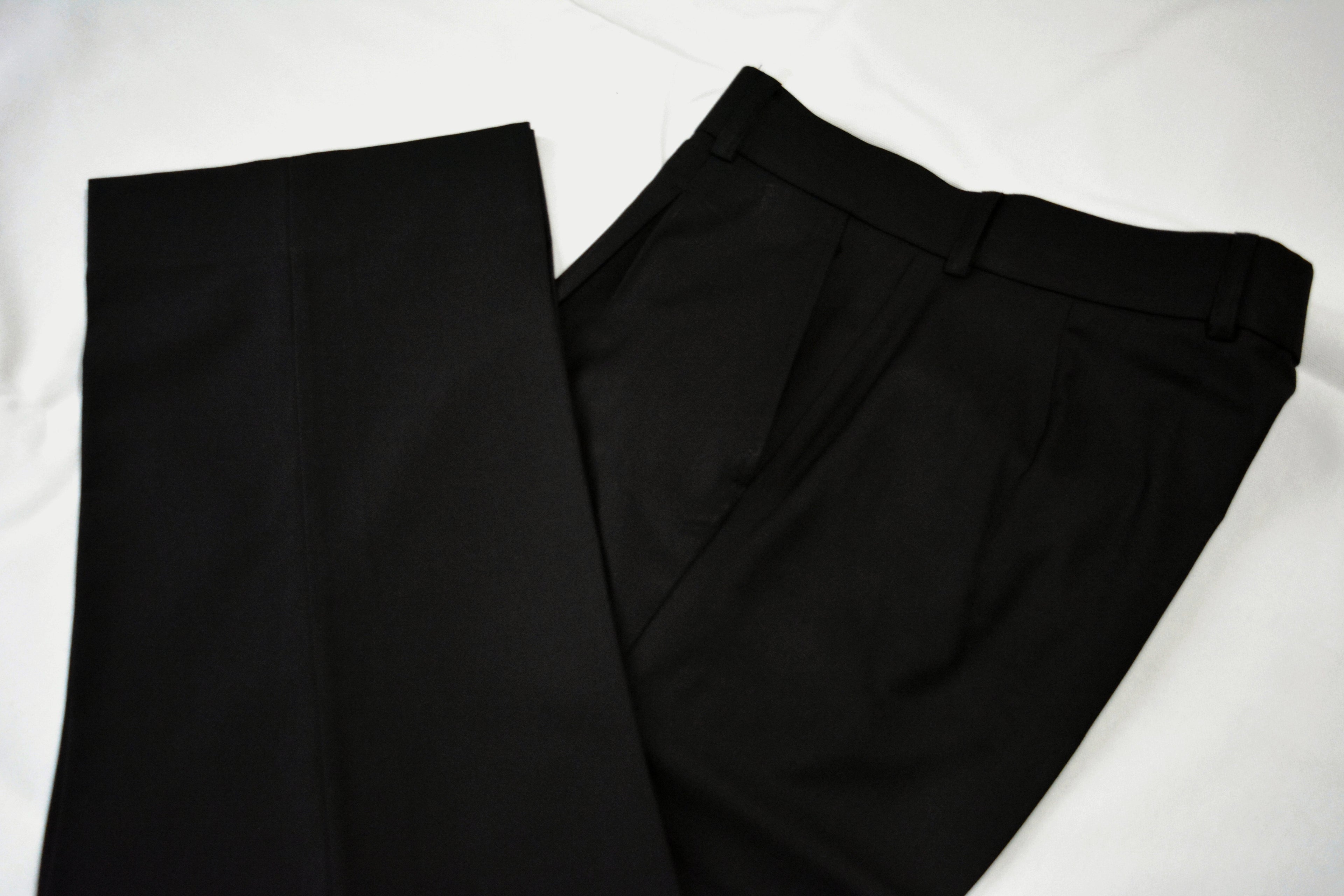 Close-up of precise black loose trousers
