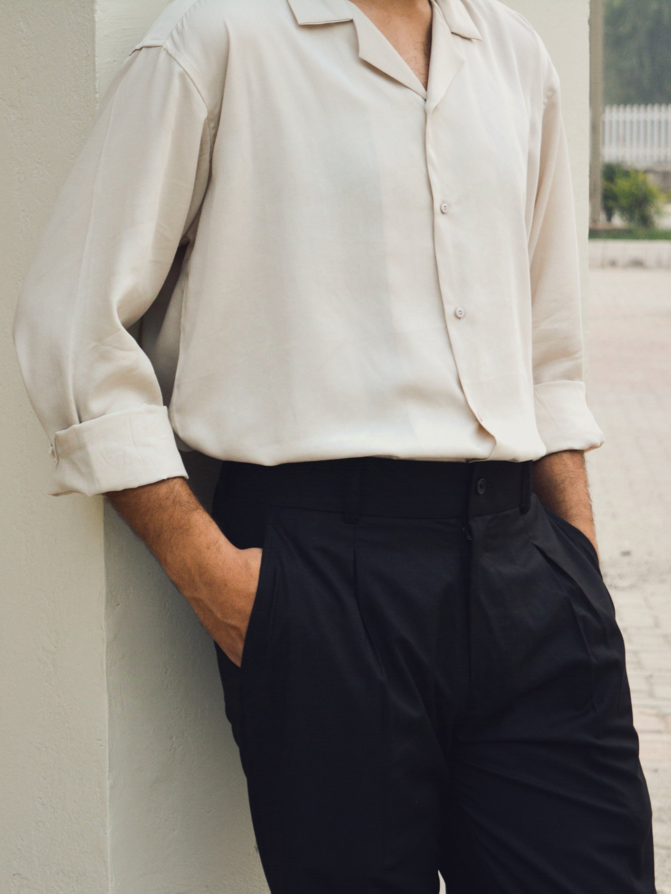 Sand cuban shirt styled classically with black pleated loose pant