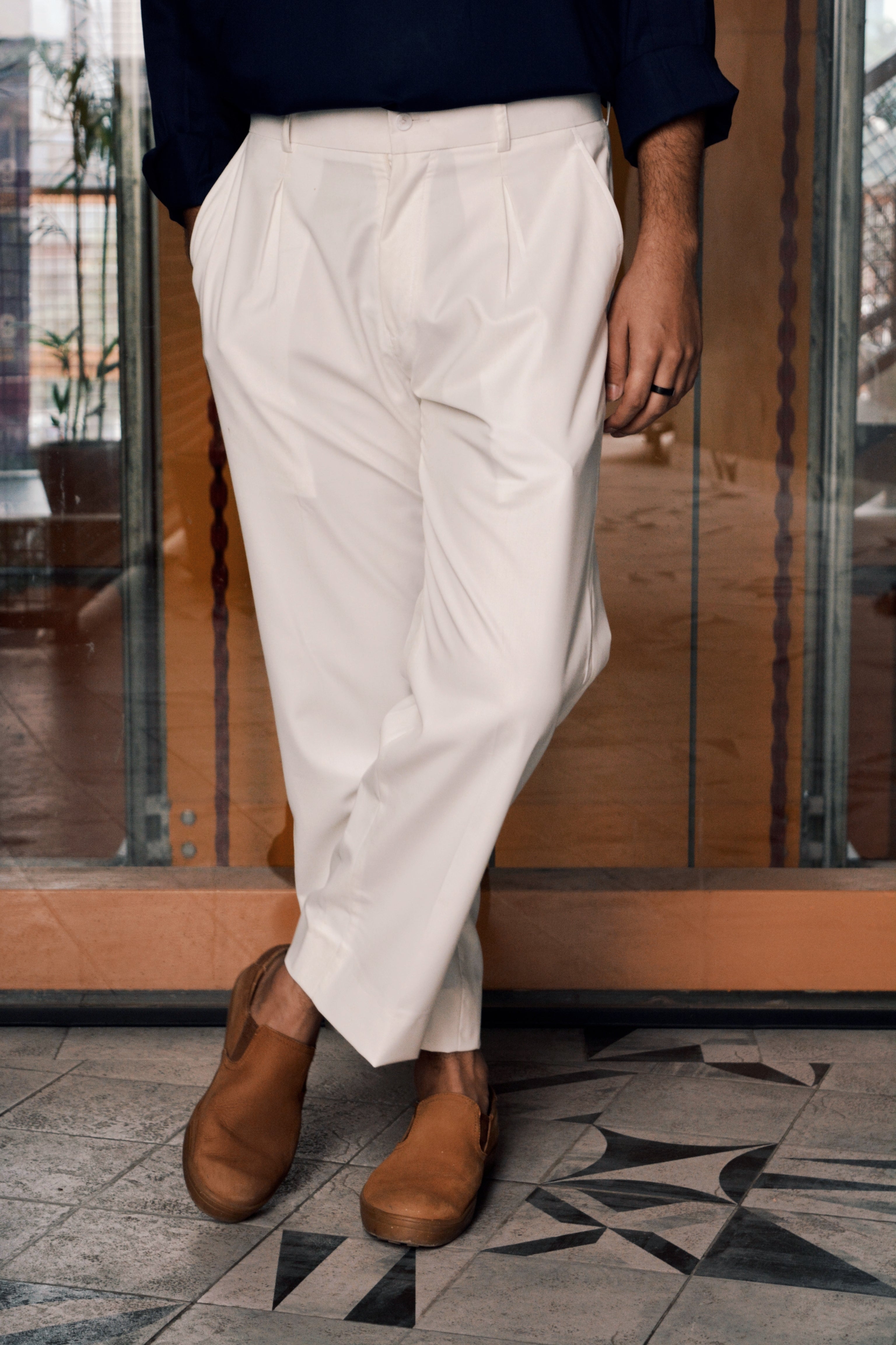 White loose pleated pants for men with relaxed fit and clean front shape
dotofficialstore